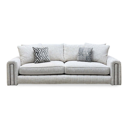 Front view of the Retreat white woven fabric 4 seater sofa with studded arms and scatter cushions