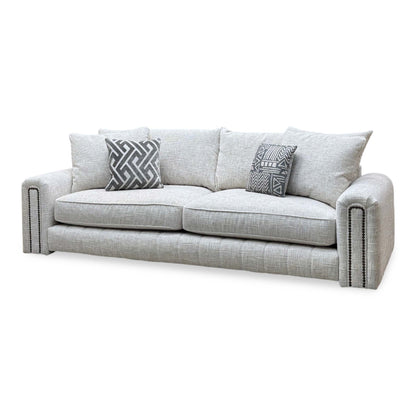 Retreat white woven fabric 4 seater sofa angled from the left showing the stud detail on the arm