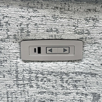 Close-up of a single power recline switch and USB-C port set into the G Plan Kingsbury mist grey fabric