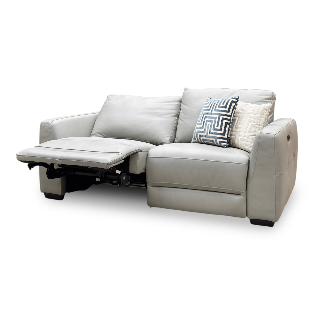 Dinky light grey leather power recliner sofa from the left with the end seat reclined and footrest extended