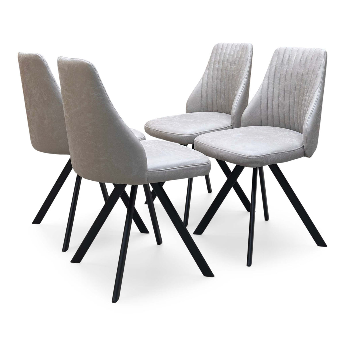 Vida taupe faux leather set of 4 swivel dining chairs, angled view with pleated backs and black legs