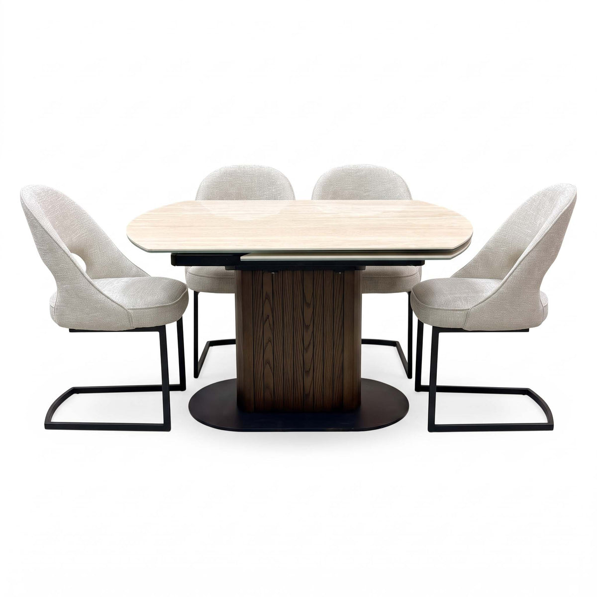 Tiber travertine ceramic table, front view with the four beige fabric cantilever chairs drawn up close to the table