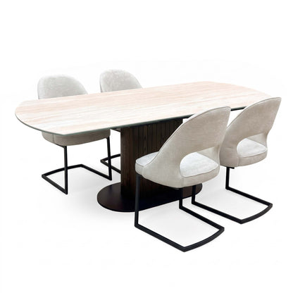 Tiber travertine ceramic extending table with four alabaster beige fabric cantilever chairs, angled view