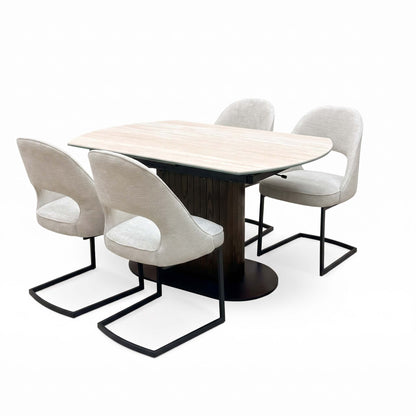 Tiber travertine ceramic table closed, angled view with the four beige fabric cantilever chairs
