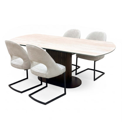 Tiber travertine ceramic table extended, angled view with the four beige fabric cantilever chairs