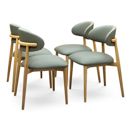 Riga olive green faux leather dining chairs angled from the left showing the curved oak back rails