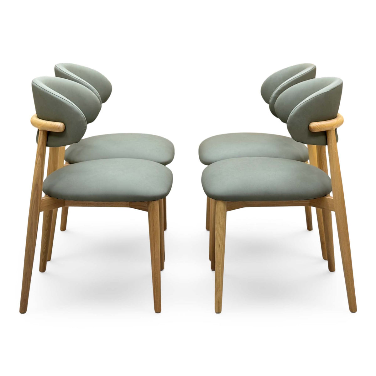 Side view of the Riga olive green faux leather dining chairs in two pairs facing each other