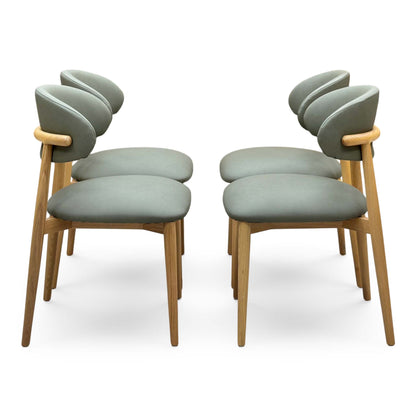 Side view of the Riga olive green faux leather dining chairs in two pairs facing each other