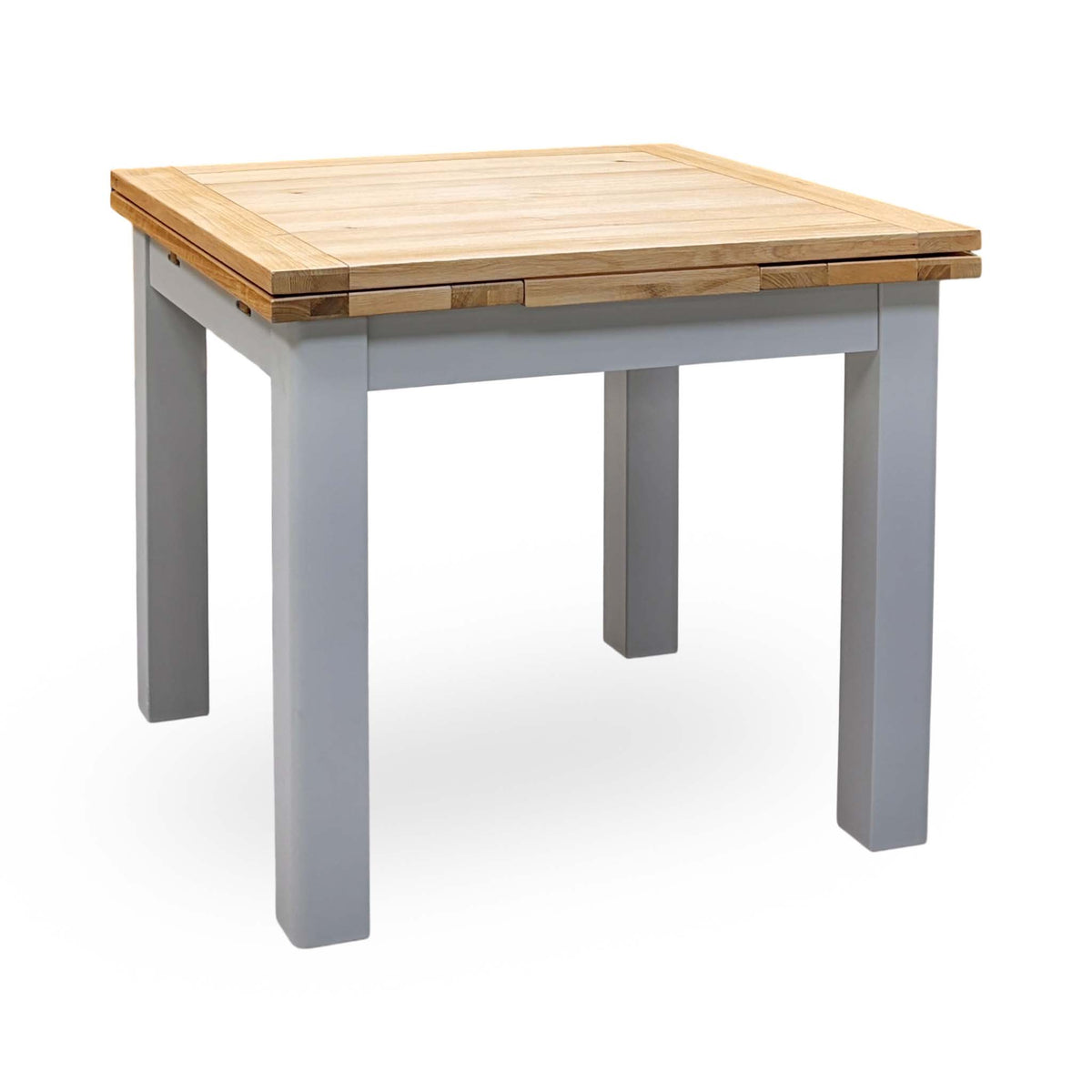 Lewis small draw leaf extending dining table with an oak top and grey painted legs, closed, angled view