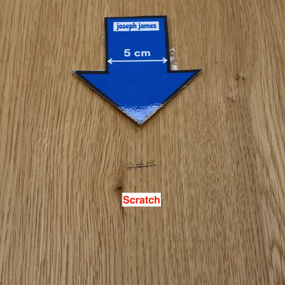 Close-up of the scratch on the Lewis dining table