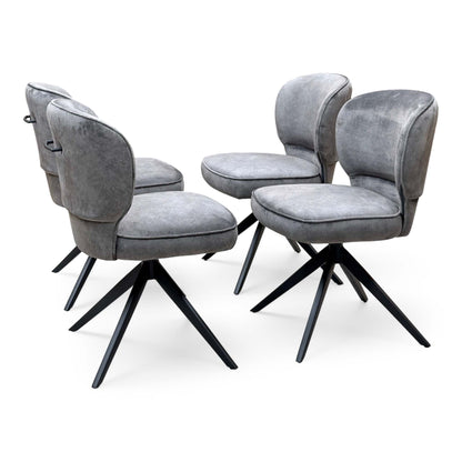 Set of four Imperium mink velvet swivel dining chairs angled, two seen from behind