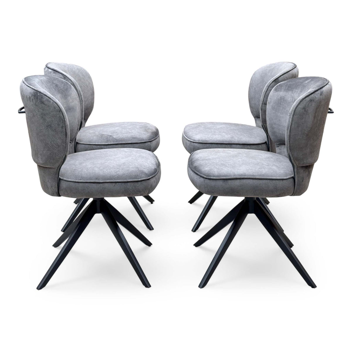 Side profiles of the four Imperium mink velvet swivel dining chairs in two facing pairs