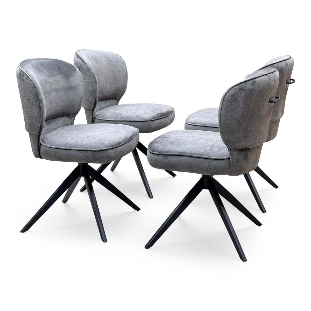Set of four Imperium mink velvet swivel dining chairs angled from the right on black four-point bases