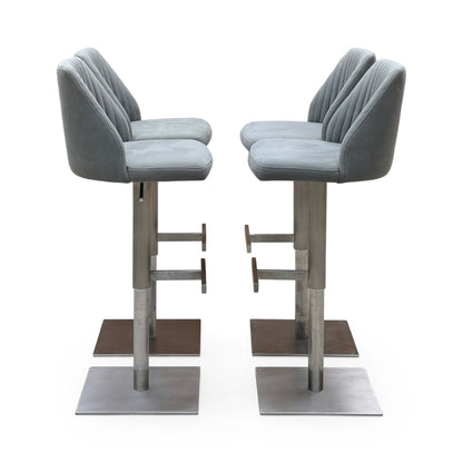 Side angle of the Grigio grey fabric bar stools showing the curved backs and footrests on steel columns