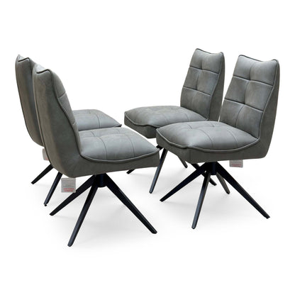 Germain charcoal grey faux leather set of 4 swivel dining chairs, angled view with quilted stitched seats
