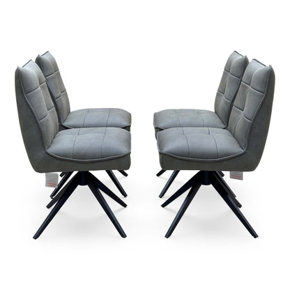 Side view of the Germain charcoal grey faux leather swivel dining chairs, two pairs facing each other
