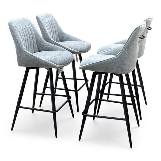 Crete light grey fabric set of 4 swivel bar stools, angled view with black metal legs and footrests