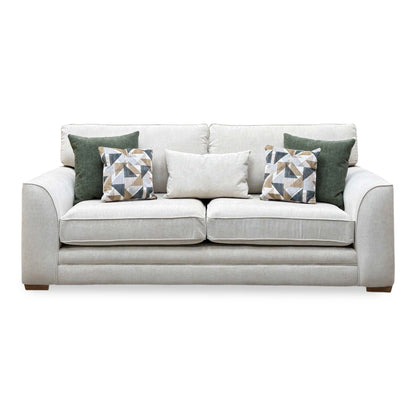 Front view of the Kaluna natural fabric 3 seater sofa with green and patterned cushions