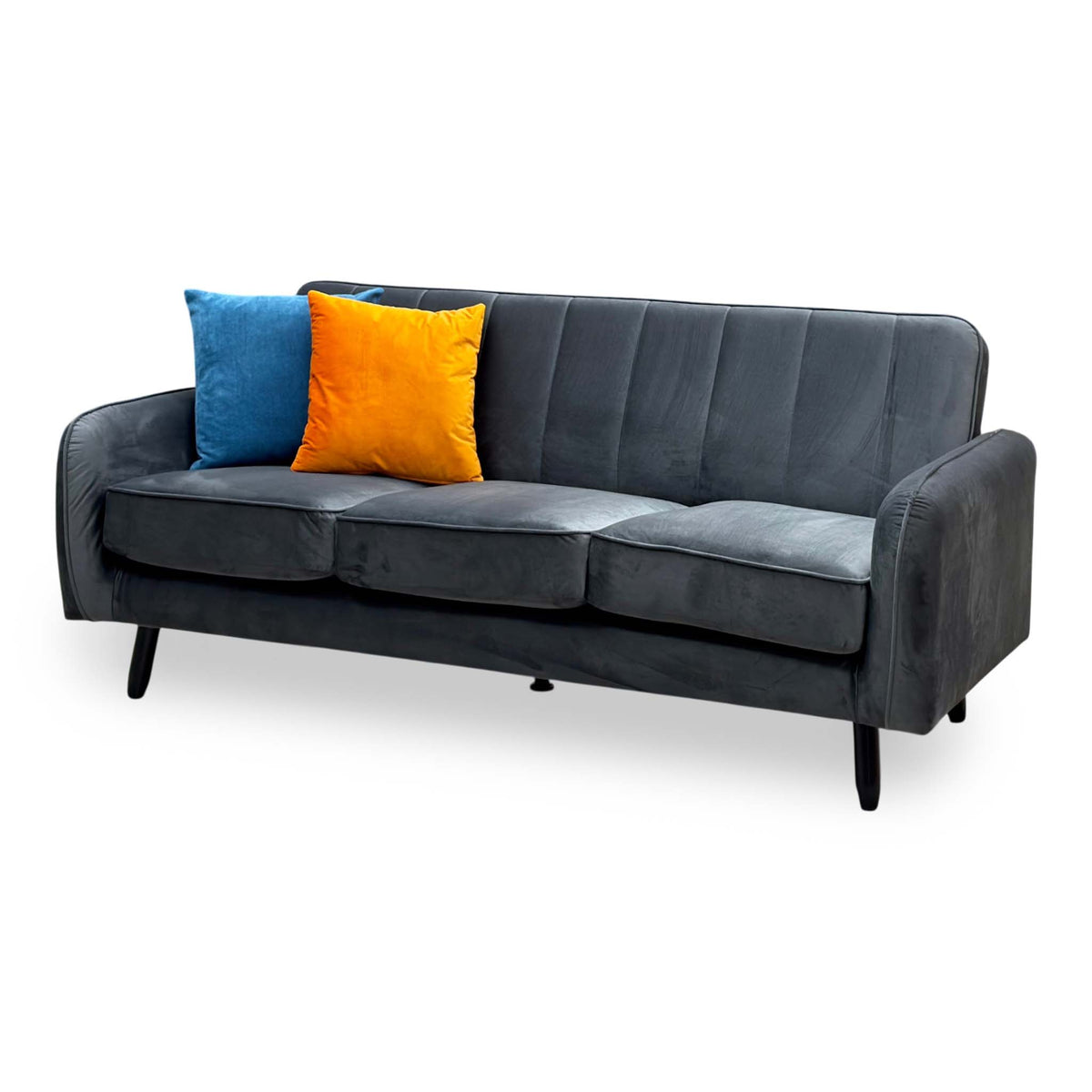 Jennifer dark grey velvet 3 seater sofa angled from the left with the three seat cushions and curved arms