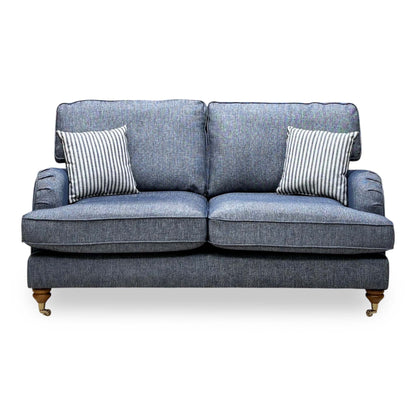 Front view of the Bay navy blue plain fabric 2 seater sofa with two striped cushions and pleated arms