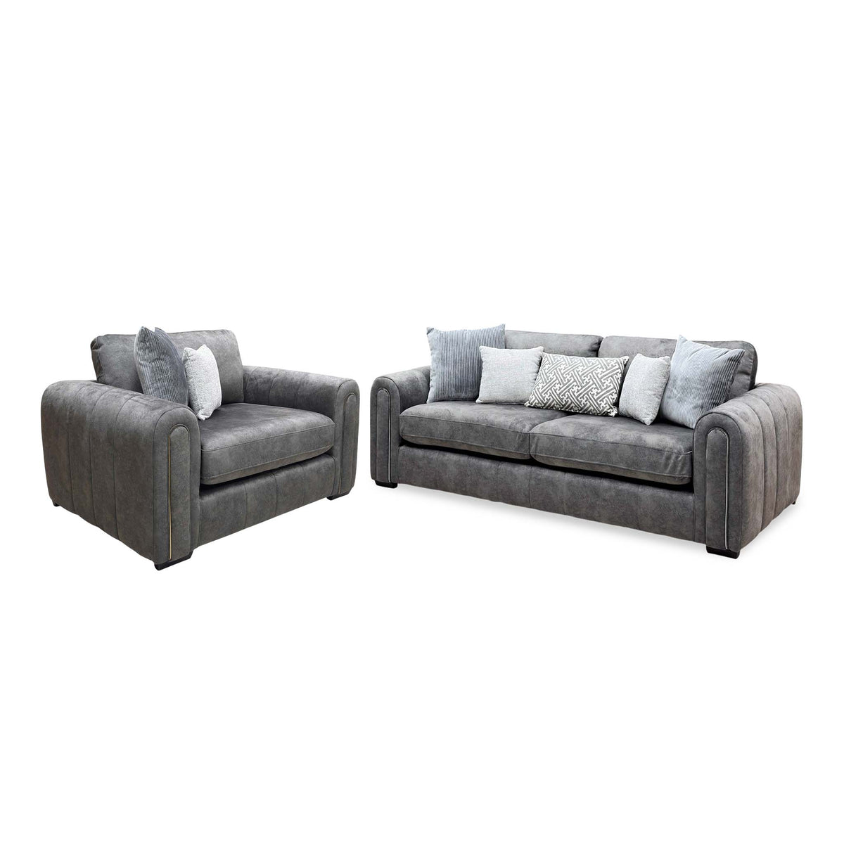 Angled view of the Amara charcoal grey velvet snuggle chair and 3 seater sofa with the snuggle chair on the left