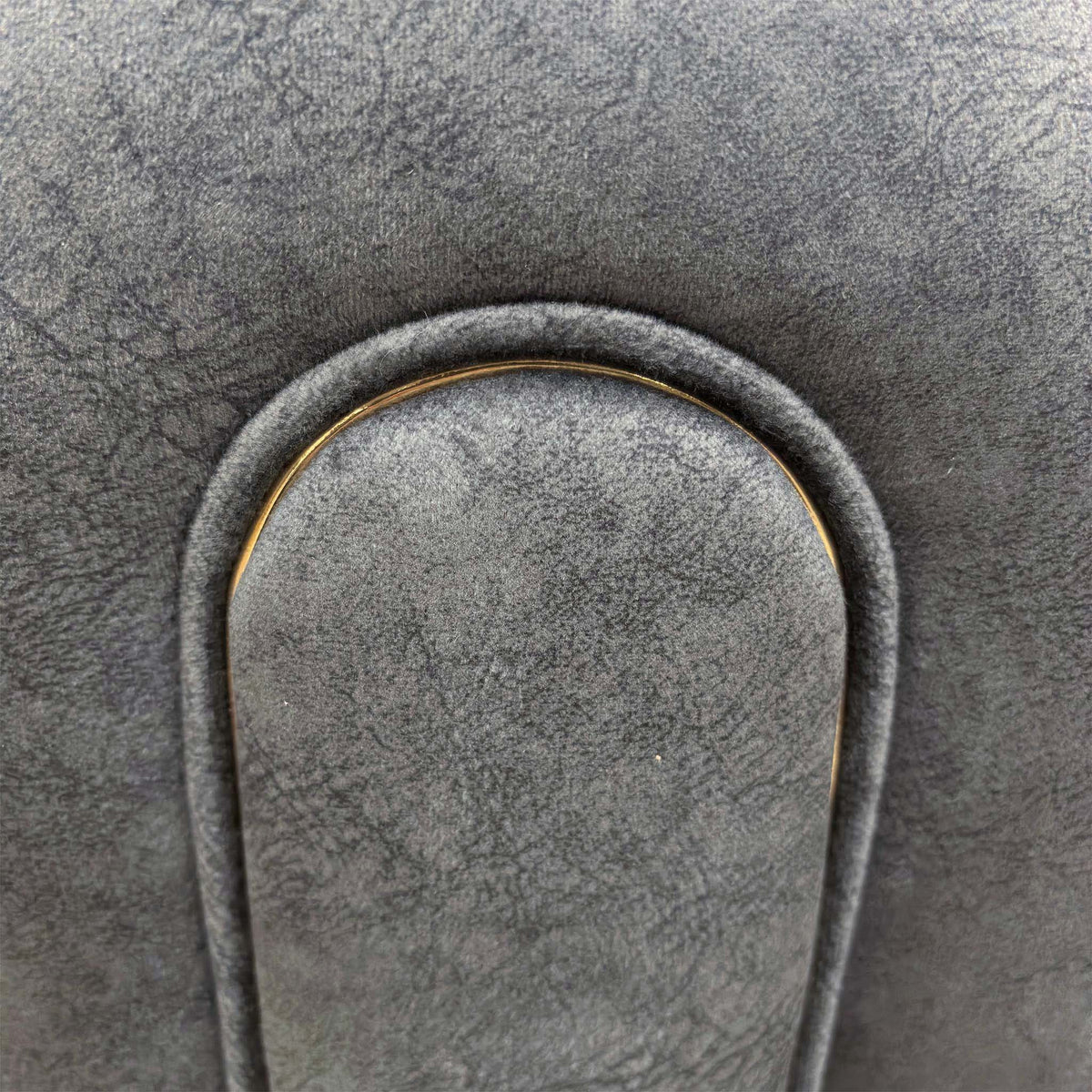 Close-up of the rolled arm panel with piped trim on the Amara charcoal grey velvet sofa