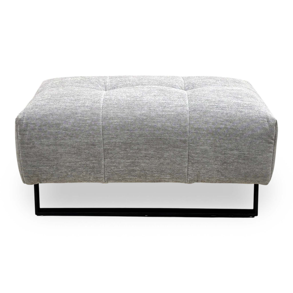 Front view of the Shelby dove grey fabric footstool showing the black metal frame base