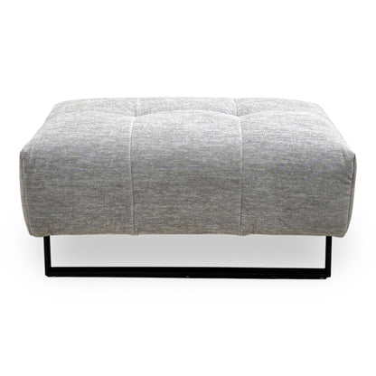 Front view of the Shelby dove grey fabric footstool showing the black metal frame base