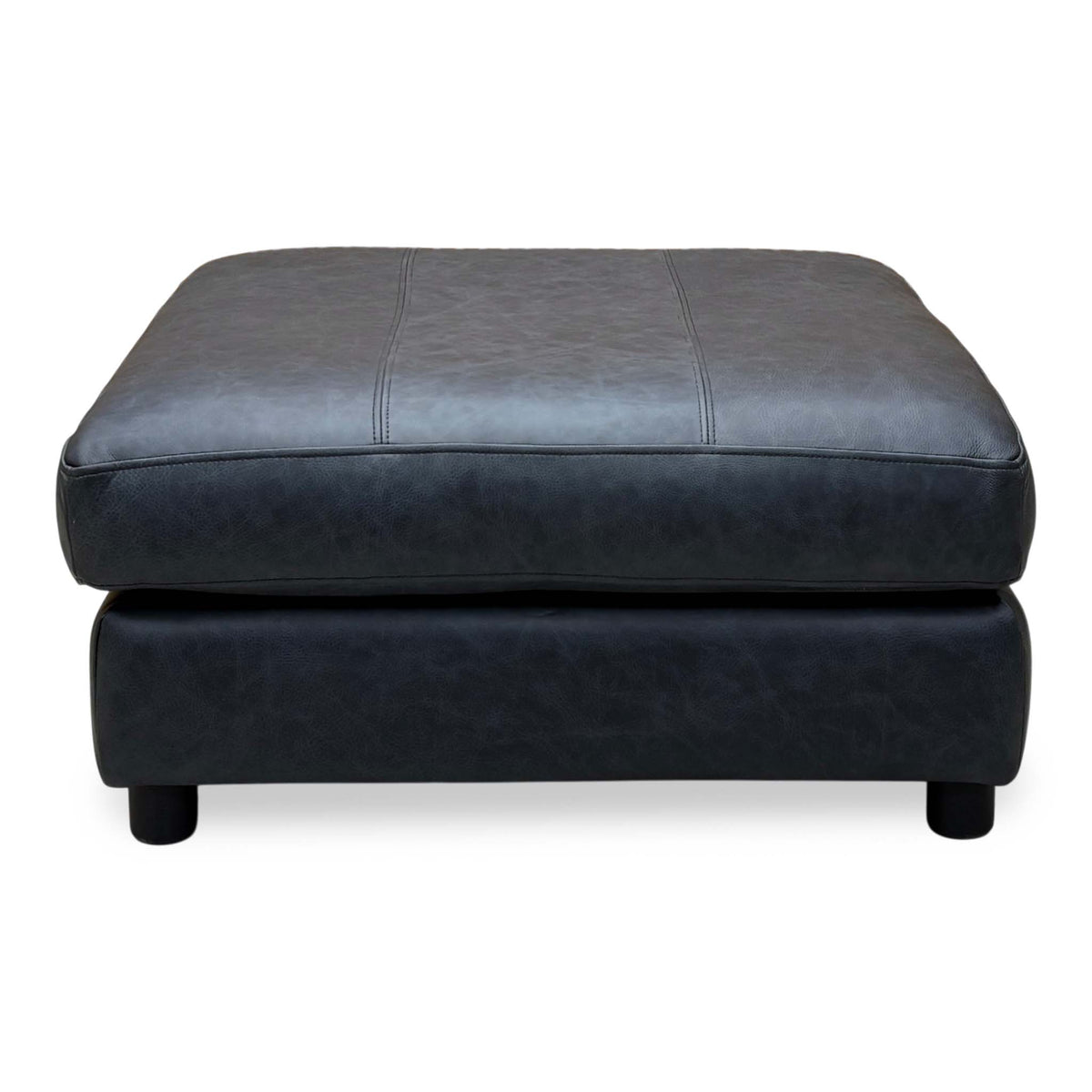 Front view of the Romilly navy blue leather footstool with its stitched cushioned top