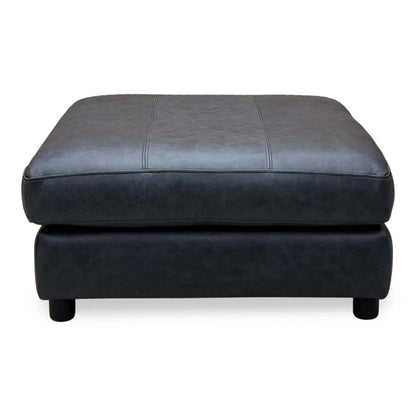 Front view of the Romilly navy blue leather footstool with its stitched cushioned top