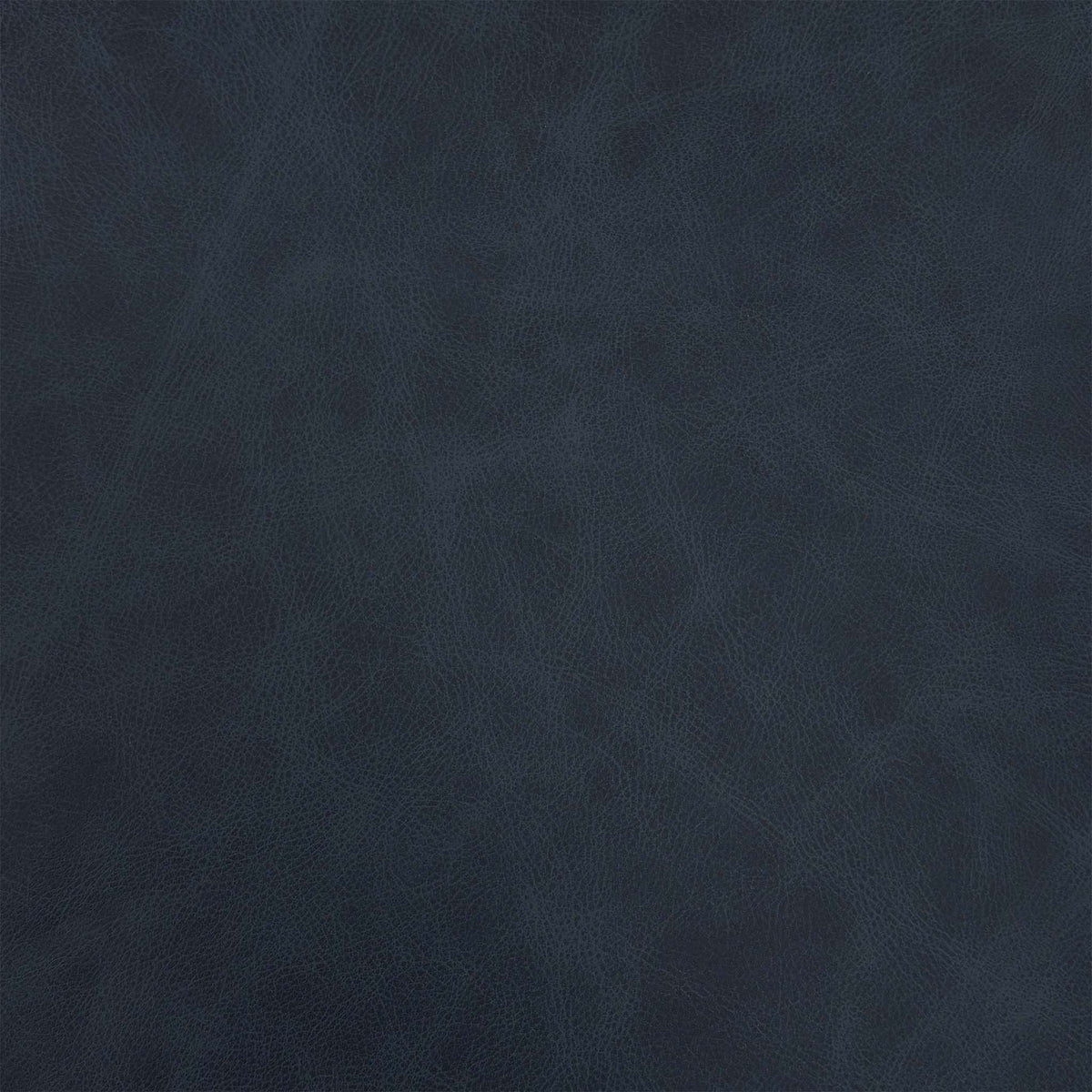 Close-up of the shadow navy blue leather used on the Romilly footstool