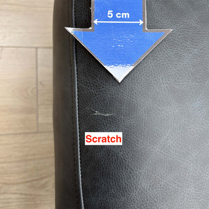 Close-up of a small scratch on the side of the Romilly navy leather footstool, marked with a 5cm arrow