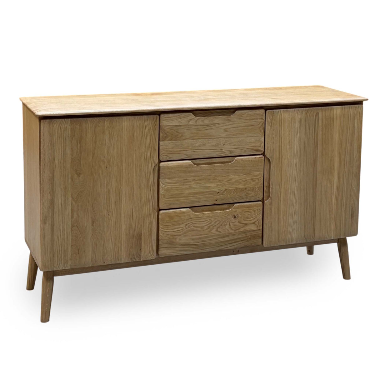 Stockholm light oak solid oak 2 door 3 drawer large sideboard, angled view on tapered legs