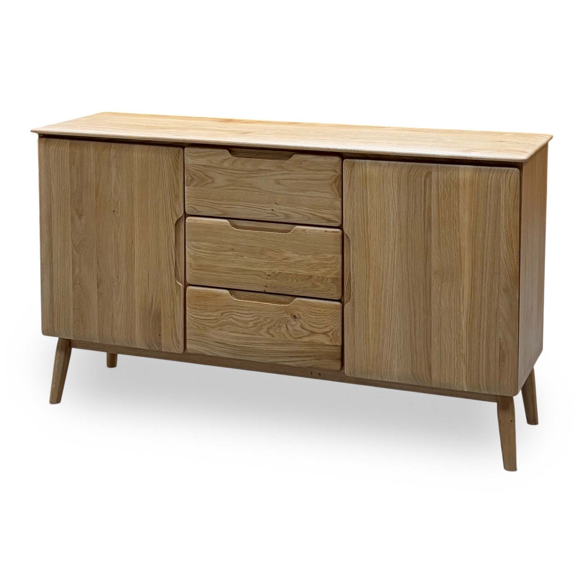 Stockholm light oak solid oak 2 door 3 drawer large sideboard, angled from the right