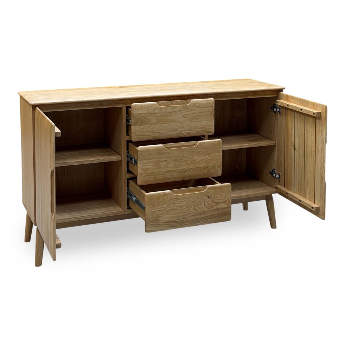 Stockholm light oak solid oak large sideboard with doors open and drawers pulled out, angled from the opposite side