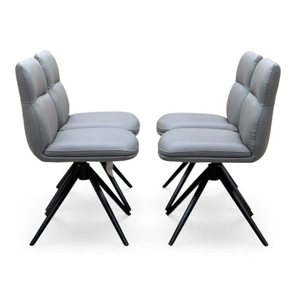 Side angle of the Quattro stone grey faux leather swivel dining chairs showing the padded backs and black legs