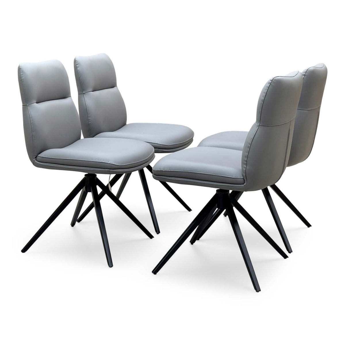 Quattro stone grey faux leather set of 4 swivel dining chairs, angled from the opposite side