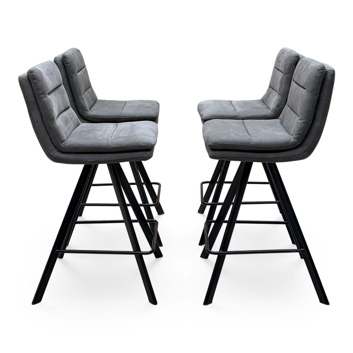 Side angle of the Bodahl Njord anthracite grey fabric bar stools showing the splayed black legs and footrests