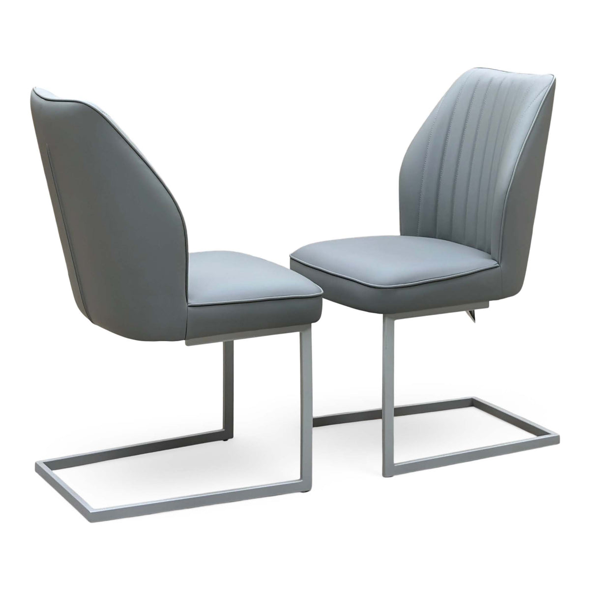 Fumo grey faux leather pair of cantilever dining chairs with pleated backs and chrome frames, one seen from behind