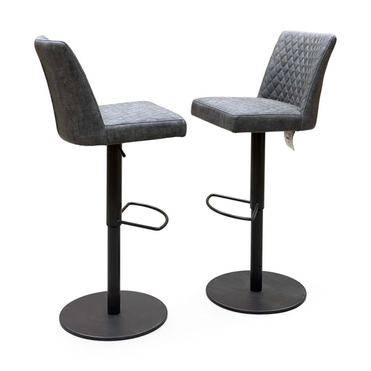 Pair of Earth grey fabric swivel bar stools, angled view showing the diamond-stitched backs and footrests