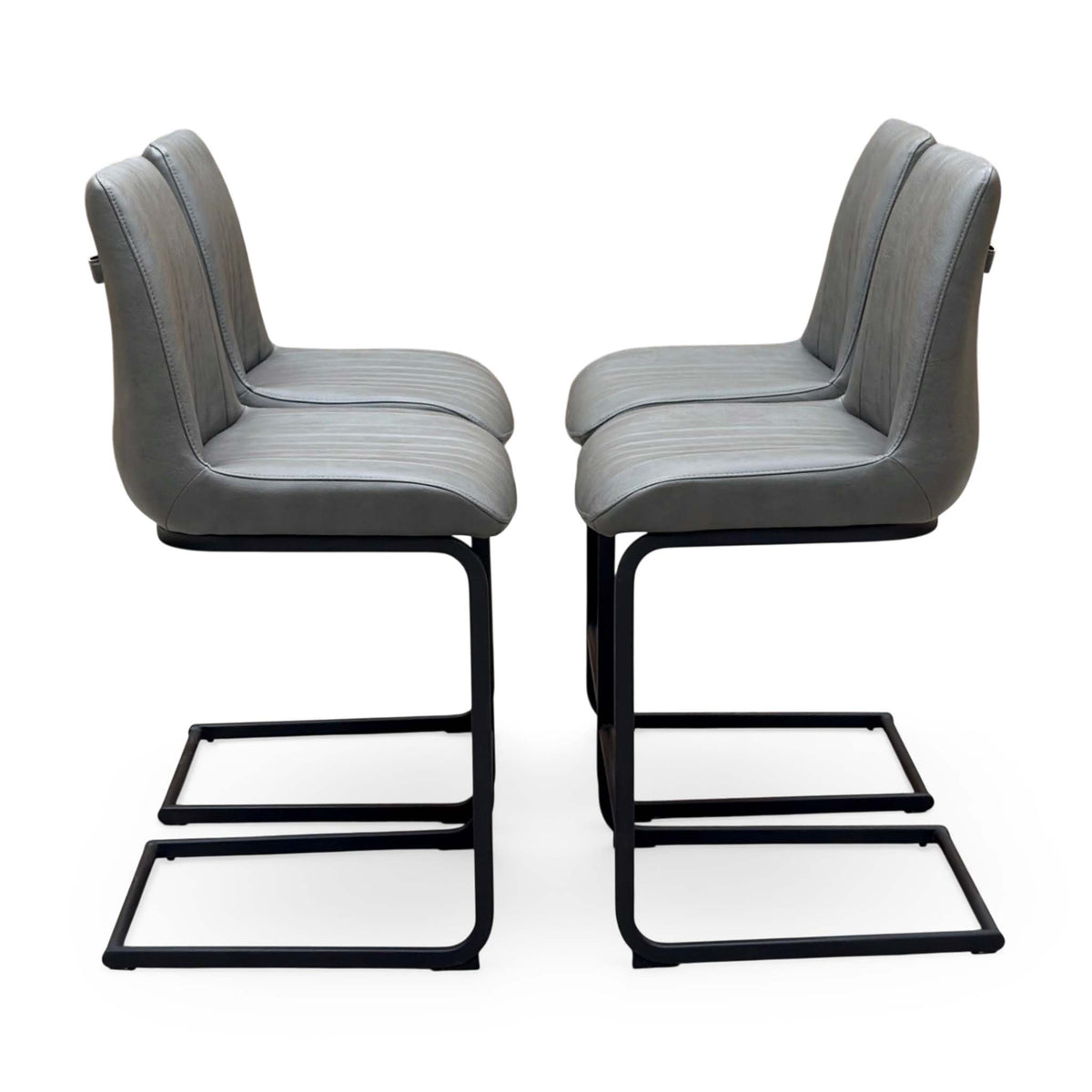 Side angle of the Terra grey faux leather bar stools showing the black cantilever frames