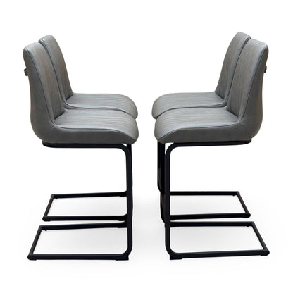 Side angle of the Terra grey faux leather bar stools showing the black cantilever frames