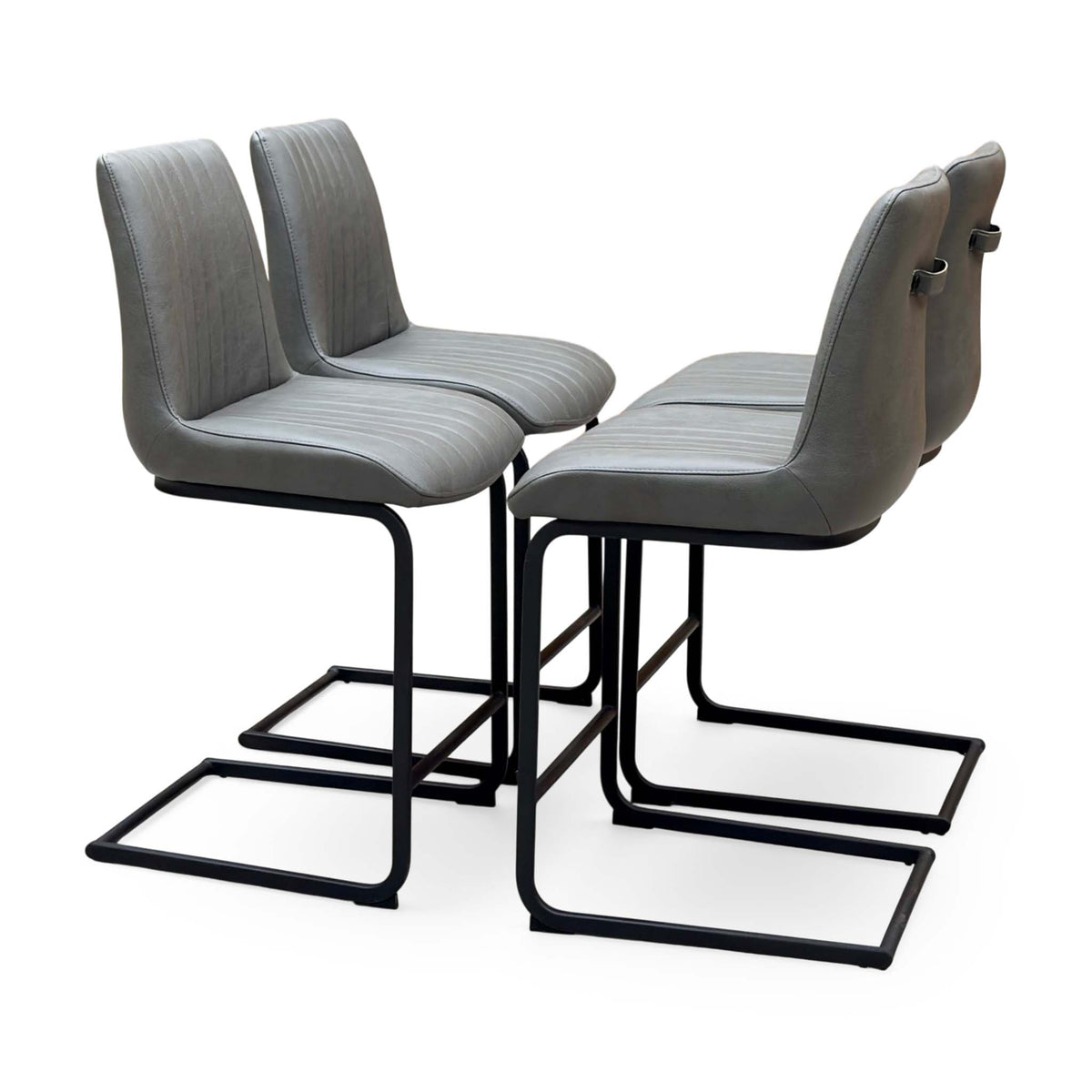 Terra grey faux leather set of 4 cantilever bar stools, angled view from the right