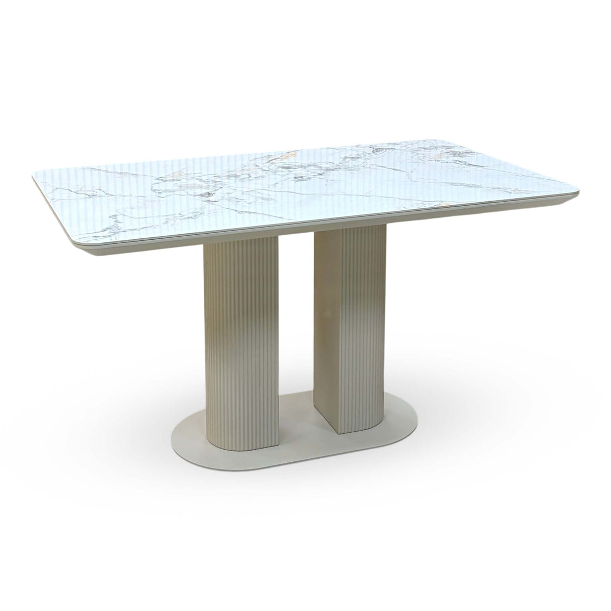 Avorio white marble effect ceramic top fixed dining table on a cream fluted twin pedestal base, angled view