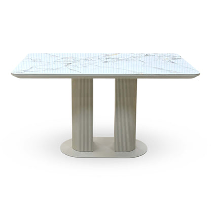 Front view of the Avorio white marble effect ceramic top fixed dining table with fluted pedestal legs