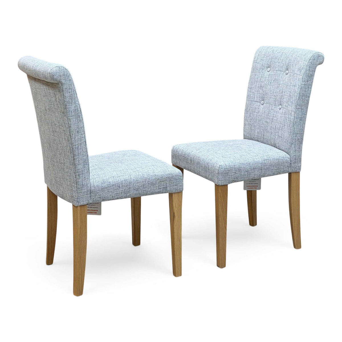 Furnitureland Augusta mist grey fabric pair of roll back dining chairs on oak legs, angled view