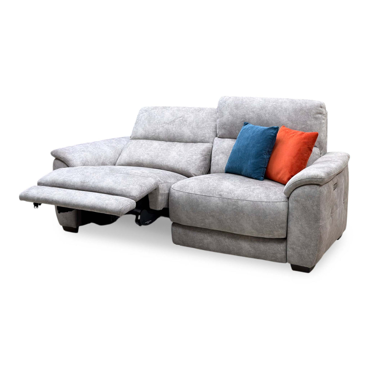 Saffron grey velvet large 3 seater power recliner sofa with the left seat fully reclined and footrest raised, angled view