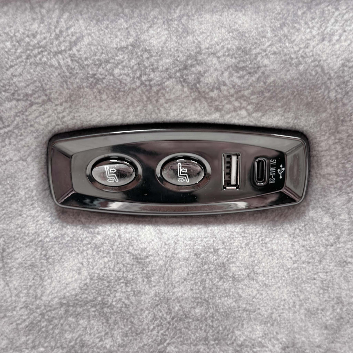 Close-up of the power recline buttons with USB-A and USB-C ports on the Saffron grey velvet sofa arm