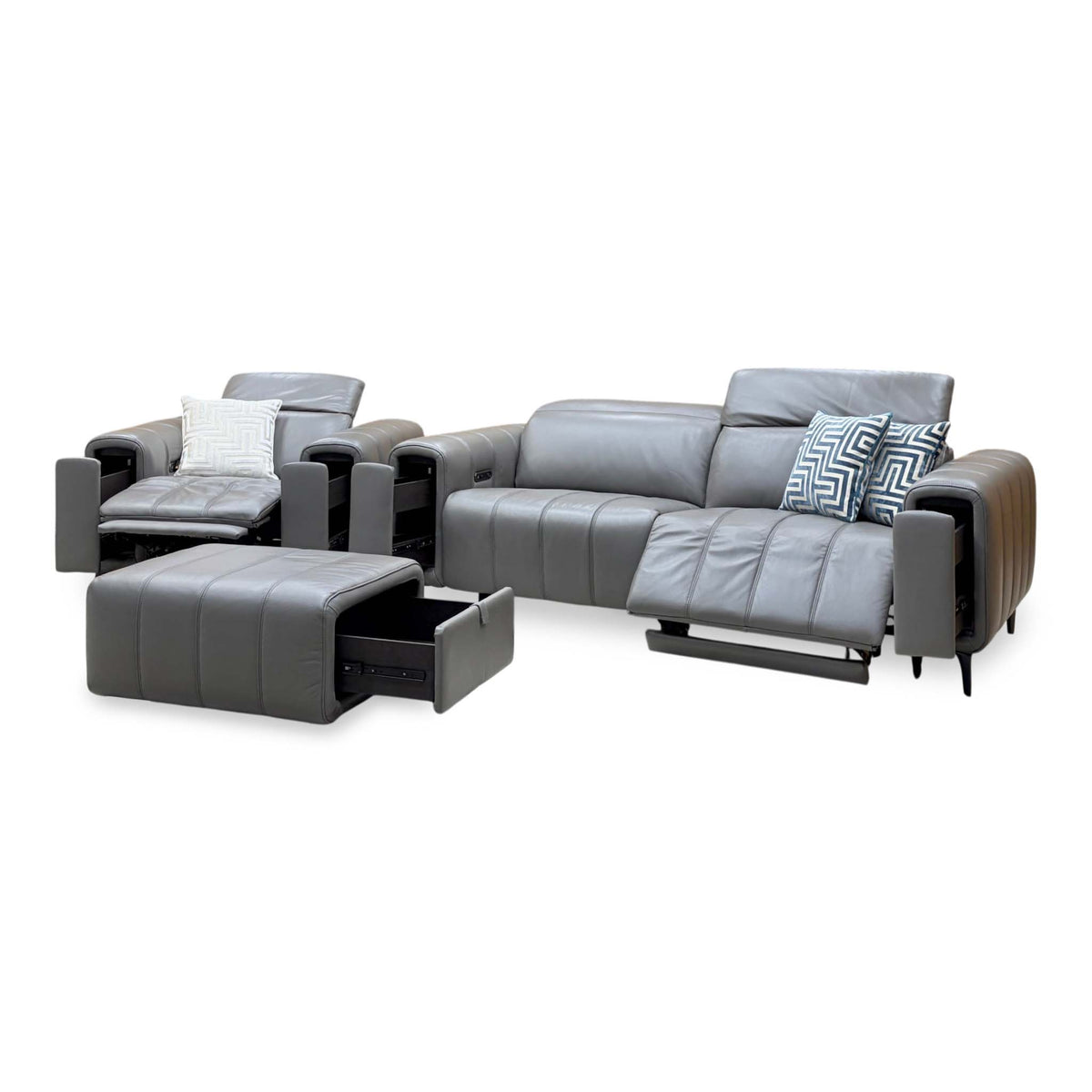 Elphaba elephant grey leather sofa and chair reclined with the storage footstool drawer pulled open, angled view