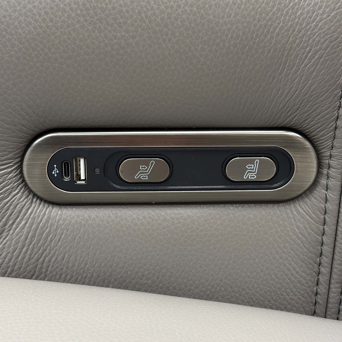Close-up of the power recline control panel with USB-C and USB-A ports on the Elphaba elephant grey leather sofa